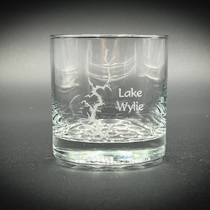 May include: A clear glass tumbler with an etched design of Lake Wylie. The glass has a textured bottom.