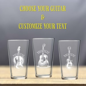 May include: Three clear glass pint glasses with different guitar designs etched on them. The glasses are on a wooden surface. The text "Choose your guitar & customize your text" is at the top of the image.