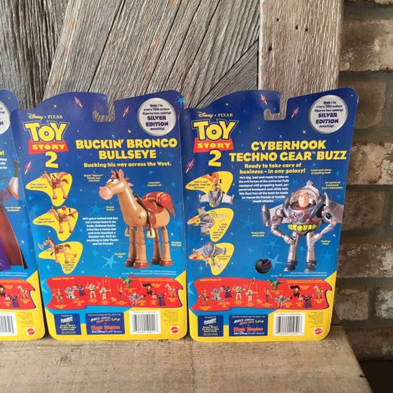 May include: Toy Story 2 action figures, including Bullseye and Techno Gear Buzz, in their original packaging. The packaging is blue and yellow with the Disney Pixar logo and Silver Edition labels. The Bullseye figure is brown and the Buzz figure is silver.