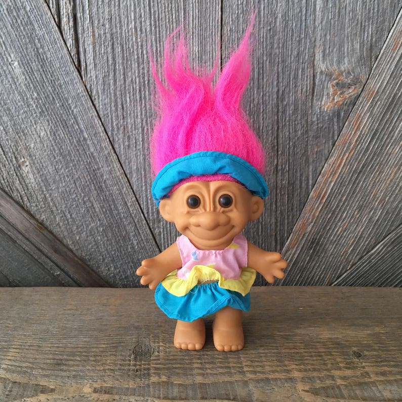 RUSS TROLL DOLL WITH PURPLE HAIR WEARING BLACK DRESS AND PINK BOA