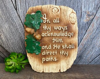 May include: A wooden plaque with a rustic brown finish and a green leaf design. The plaque features the text "In all thy ways acknowledge Him and He shall direct thy paths".