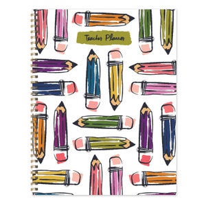 May include: A white spiral bound planner with a colorful pencil pattern and the text "Teacher Planner" on the cover.