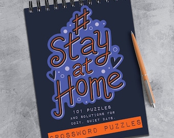 May include: A blue and orange spiral bound notebook with the text "#Stay at Home" and "101 Puzzles and Solutions for Cozy, Quiet Days. Crossword Puzzles".