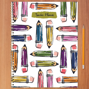 May include: A white spiral bound planner with a colorful pencil pattern and the text "Teacher Planner" on the cover.