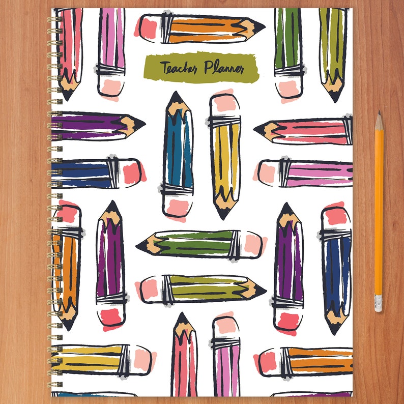 May include: A white spiral bound planner with a colorful pencil pattern and the text "Teacher Planner" on the cover.