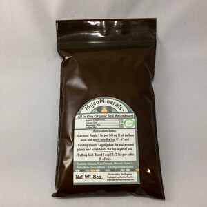 May include: Brown resealable bag with a white label that reads "MycoMinerals All In One Organic Soil Amendment". The label lists the percentage of soluble potash, calcium, magnesium, and sodium. The label also includes application rates for gardens, existing plants, and potting soil. The bag is labeled "Net. Wt. 8oz."