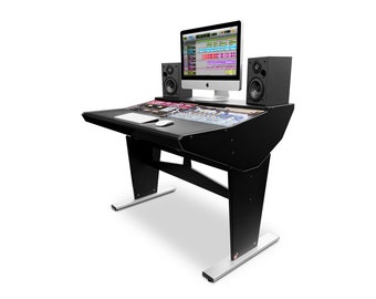 May include: Black music production desk with a computer monitor, keyboard, and mouse. Two black speakers are on either side of the monitor. The desk has a silver base.