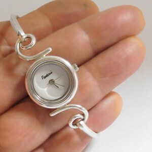 Vintage sterling silver PARTOVI watch. Never worn. MOP dial. Easy to wear. New battery. Works great
