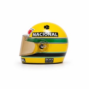 May include: A yellow racing helmet featuring a green and black horizontal stripe pattern. The word NACIONAL is printed in black on a white background. The helmet includes a tinted visor and a BOSS logo on the lower side with black trim.