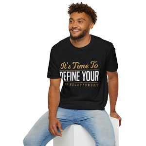 May include: A black t-shirt with the text "It's Time To Define Your Relationship" in white and gold lettering.