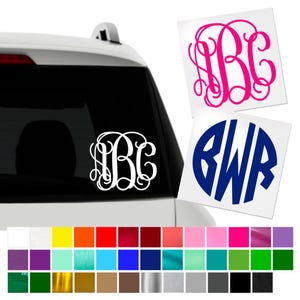 May include: White, pink, and blue monogram decals. The white decal is on a car window. The pink decal features the letters "BC" in a curly font. The blue decal has the letters "BWR" in a bold font. A color chart is at the bottom.