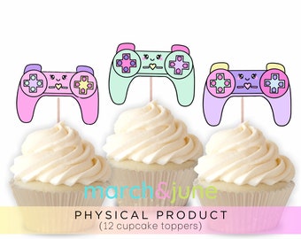 May include: Set of 12 cupcake toppers featuring pastel-colored game controllers with cute faces. Each topper has a heart and a stick for inserting into cupcakes.
