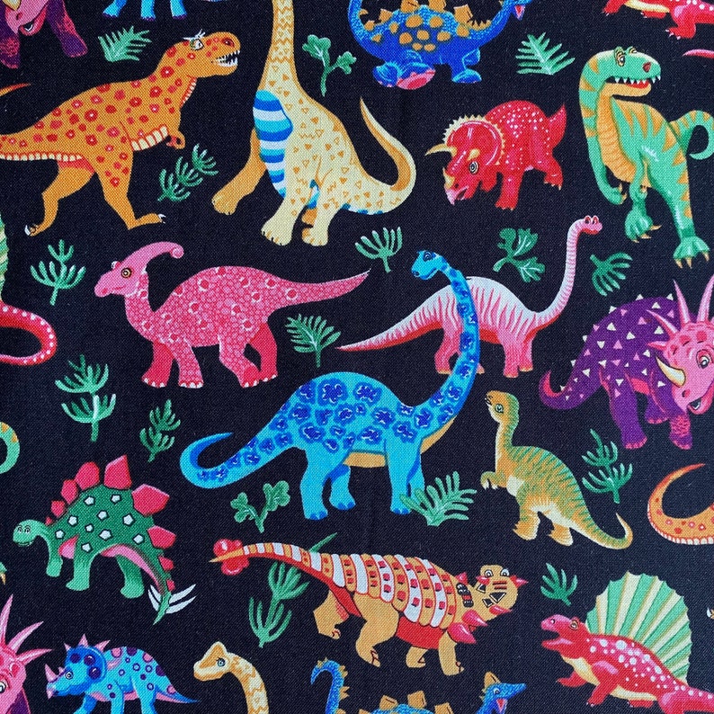 May include: A black background is covered with a colorful pattern of various dinosaurs. The dinosaurs are in shades of orange, yellow, pink, blue, green, and purple. Some have spots, stripes, or other patterns. Green plant-like shapes are scattered throughout.