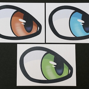 May include: Three cartoon eyes with white scleras, black pupils, and different colored irises. The irises are orange, blue, and green.