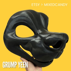 May include: A black, 3D printed animal mask with a detailed snout and large eye holes. The mask is held in a hand, with the text "GRUMP YEEN" visible below.