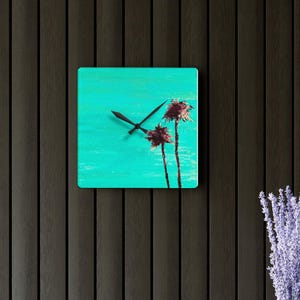 May include: A turquoise blue clock with black hands and a painted image of two palm trees. The clock is on a dark wood background.