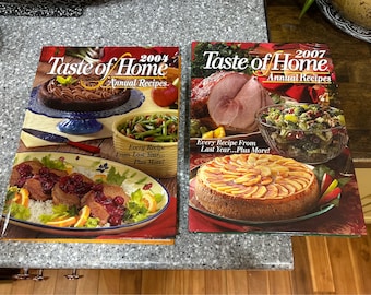 May include: Two Taste of Home cookbooks, one from 2004 and one from 2007. Both feature colorful food photography and the text "Every Recipe From Last Year... Plus More!"