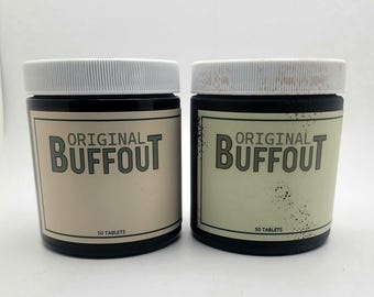 May include: Two black jars with white lids and labels that read "ORIGINAL BUFFOUT" in a bold, stylized font. The labels are a light beige color. The text "50 TABLETS" is printed at the bottom of the labels.