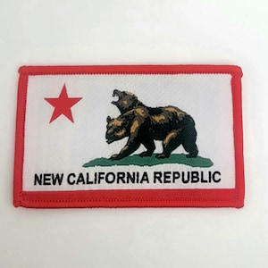 May include: Embroidered patch featuring the New California Republic flag. The design includes a red star, a two-headed bear, and the text "NEW CALIFORNIA REPUBLIC" on a white background with a red border.