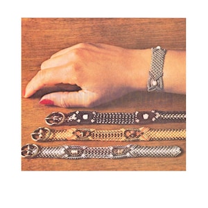 May include: Four woven bracelets with different colored threads and beads. The bracelets have a buckle closure.