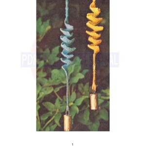 May include: Two hanging wind chimes with a spiral design. The wind chime on the left is blue and the wind chime on the right is yellow. Both wind chimes have a small bell at the bottom.