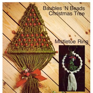 May include: A handmade macrame Christmas tree with red bead decorations and a red bow, with a mistletoe ring and wrapped gifts. The image includes the text "Baubles 'N Beads Christmas Tree" and "Mistletoe Ring". The gifts are wrapped in brown paper with floral ribbon.