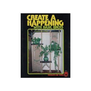 May include: Book cover with the title "Create A Happening With Basic Knots" in yellow letters on a black background. The cover features a photo of a macrame wall hanging with plants.