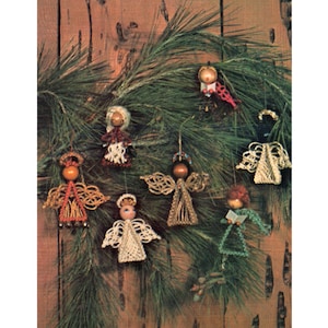 May include: Seven handmade beaded angel ornaments hanging on a pine branch. The angels are made with different coloured beads and have wooden heads.