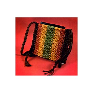 May include: A multi-colored crocheted bag with a brown strap and tassels. The bag has a striped pattern of orange, yellow, green, and brown.