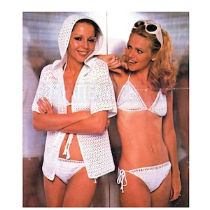 May include: Two women wearing white crocheted bikini tops and bottoms. One woman is wearing a white crocheted hooded cover-up.
