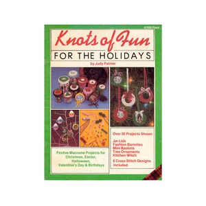 May include: A book cover with a green background and the title "Knots of Fun for the Holidays" by Judy Palmer. The cover features a variety of macrame projects, including jar lids, fashion barrettes, mini baskets, tree ornaments, and kitchen witch decorations. The book includes 6 cross stitch designs.