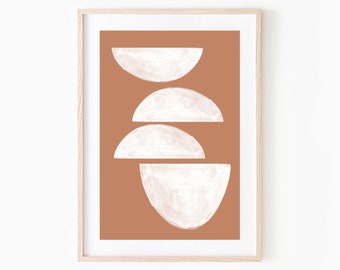 May include: Abstract art print featuring four white, semi-circular shapes against a terracotta background. The artwork is framed in a light wood frame, creating a minimalist and modern aesthetic. The print is suitable for home or office decor.
