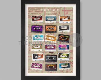 May include: A framed print of a vintage Rolling Stones album cover with a collage of cassette tapes featuring song titles like "Honky Tonk Women", "Start Me Up", and "Angie".