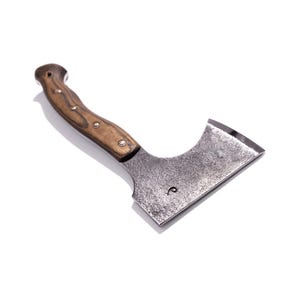 May include: A small, hand-forged axe with a wooden handle. The axe head is made of dark metal and has a curved blade. The handle is a light brown color and is secured with small metal rivets. The axe is designed for chopping and cutting.