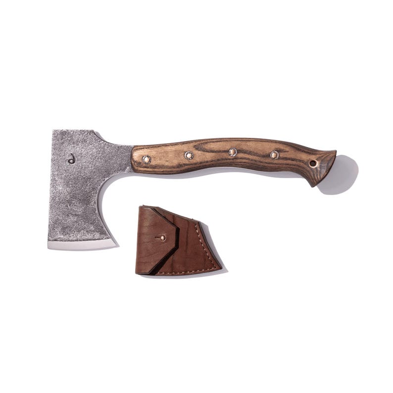 May include: A small hatchet with a wooden handle and a metal head. The handle is a light brown color with a wood grain pattern. The hatchet head is silver. A brown leather sheath is included.