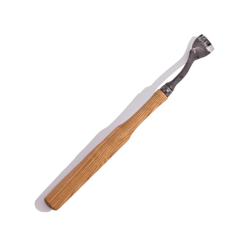 May include: A wooden handled carving tool with a curved metal blade. The tool is made of metal and wood.