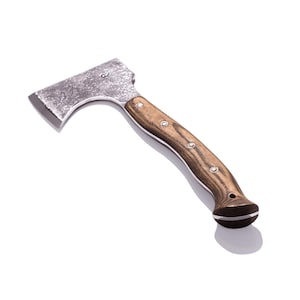 May include: A small hatchet with a weathered steel head and a wooden handle. The handle is a light brown color with a dark brown end and is secured with silver rivets. The hatchet is designed for outdoor use.