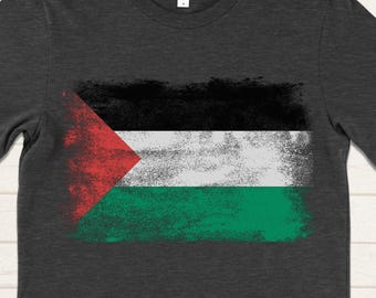 May include: A dark gray t-shirt with a distressed Palestinian flag design.