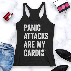 May include: Black tank top with white text that reads "Panic Attacks Are My Cardio" with a small heart symbol.