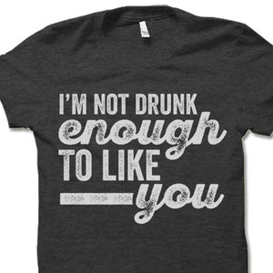 May include: A dark gray t-shirt with a white graphic that reads "I'm not drunk enough to like you".