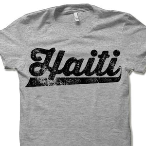 May include: A gray t-shirt with a black vintage-style graphic that says "Haiti".