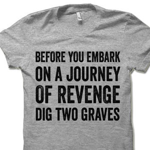 May include: Gray t-shirt with the text "Before you embark on a journey of revenge dig two graves" printed in black.