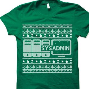 May include: Green t-shirt with a white pixelated design of a computer monitor with the text "SYSADMIN" and a row of servers. The design is reminiscent of a Christmas sweater.