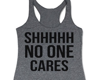May include: A heather gray tank top with the text "SHHHHH NO ONE CARES" printed in black.