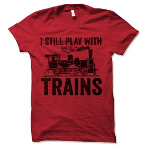 May include: Red t-shirt with a black vintage train graphic and the text "I still play with trains".