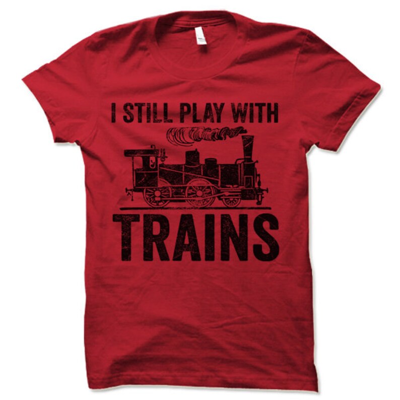May include: Red t-shirt with a black vintage train graphic and the text "I still play with trains".