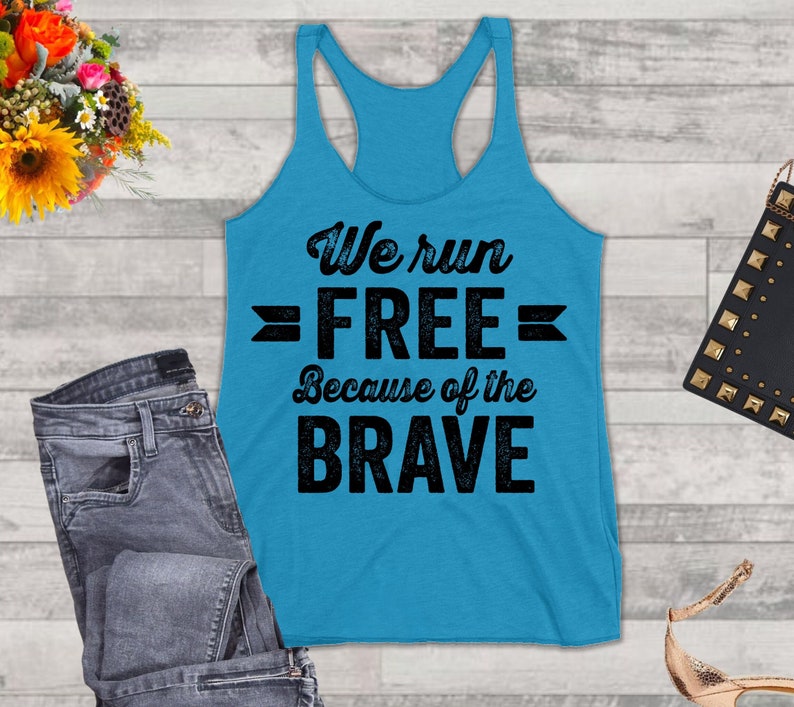 May include: A turquoise blue tank top with a black graphic that reads "We run FREE Because of the BRAVE".