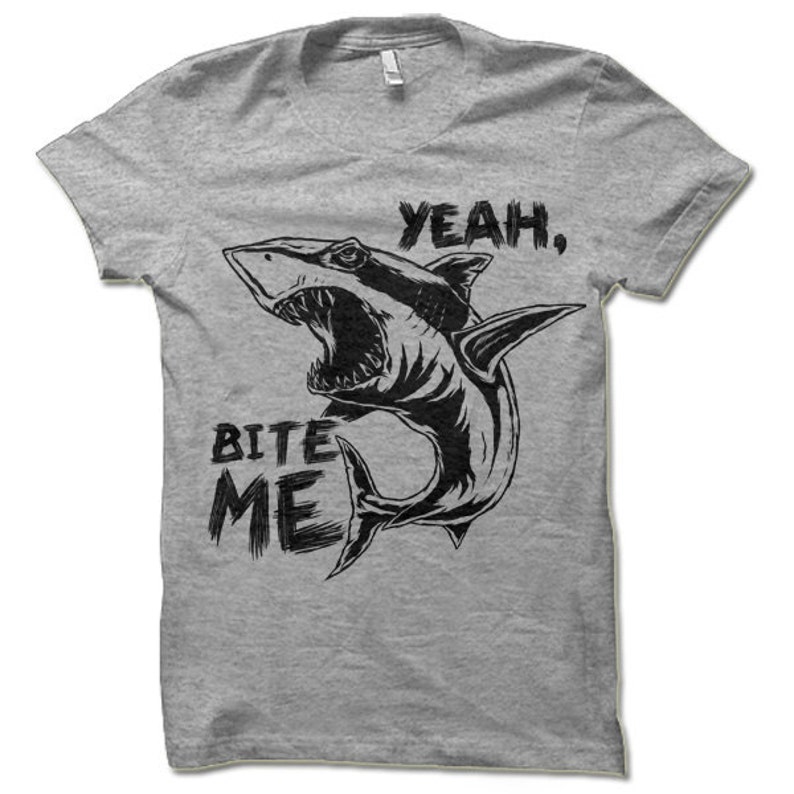 May include: Gray t-shirt with a black and white illustration of a shark with an open mouth and the text "Yeah, Bite Me".