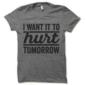 May include: Grey marl t-shirt with a black graphic that reads "I want it to hurt tomorrow".