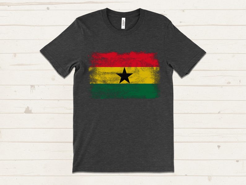 May include: A dark grey t-shirt with a distressed, faded print of the flag of Ghana. The flag is red, yellow, green, and black with a black star in the center.
